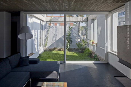 Living room in the foreground and courtyard in the background